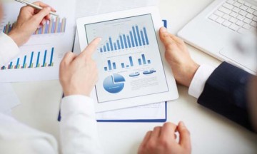 Hands pointing to graphs and tables