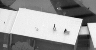 Image of detainees on roof during Banksia Hill riot in Jan 2013