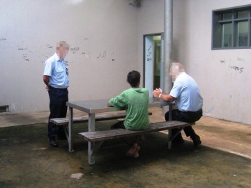 Photo of briefing a youth in a lockup before a transport