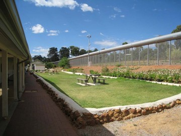 Image of a picnic table inside the perimetre fence at Wooroloo Prison Farm