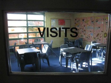 Image of a view through a window into the Visits Room at Rangeview Remand Centre