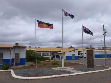 Photo of 3 flags outside prison