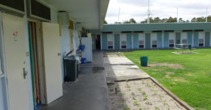 Photo of prison cell doors and grassed yard area
