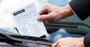 Parking violation ticket on car windscreen