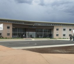 Image of the Young Adults Facility taken from outside with Young Adults playing on a basket ball court