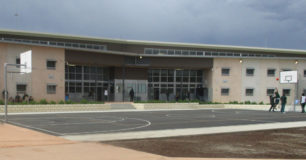 Image of the Young Adults Facility taken from outside with Young Adults playing on a basket ball court