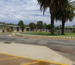 Image of grassed area with seating and accommodation blocks around this area.