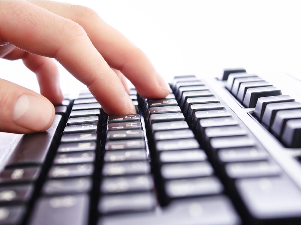 Photo of hands on a keyboard
