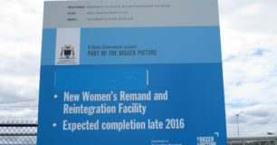 Image of a sign about the "New Women's Remand and Reintegration Facility" outside Melaleuca