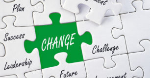 Image of a white jigzaw puzzle with words, and the word change in white with a green background