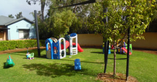 Image of childrens toys on the grass outside residents communal houses at Boronia Pre-release Centre for Women