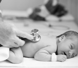 Image of baby being checked with a stethoscope