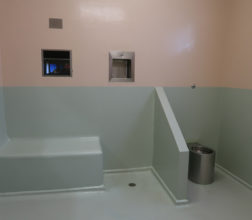 Image of a Seat and toilet in a court custody cell
