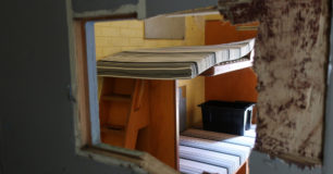 Image of looking through damaged Cell door into Cell in Unit 3