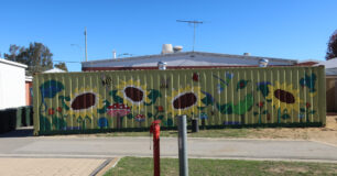 Image of a mural on a sea container behind reception building at Bandyup Women's Prison