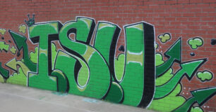 Graffiti art of the name 'Isu' on wall in basketball court