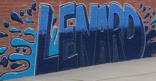 Graffiti art of the name 'Lenard' unit on wall in the basketball court