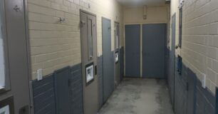Image of corridor at Greenough Regional Prison in Unit 1 with cell doors to the left.