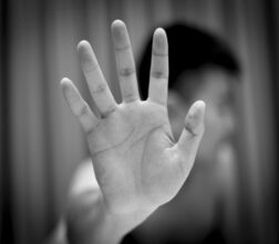 Image of man holding his hand out in front of him, to say stop