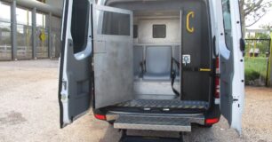 Image of transfer van with the back doors and pod door open