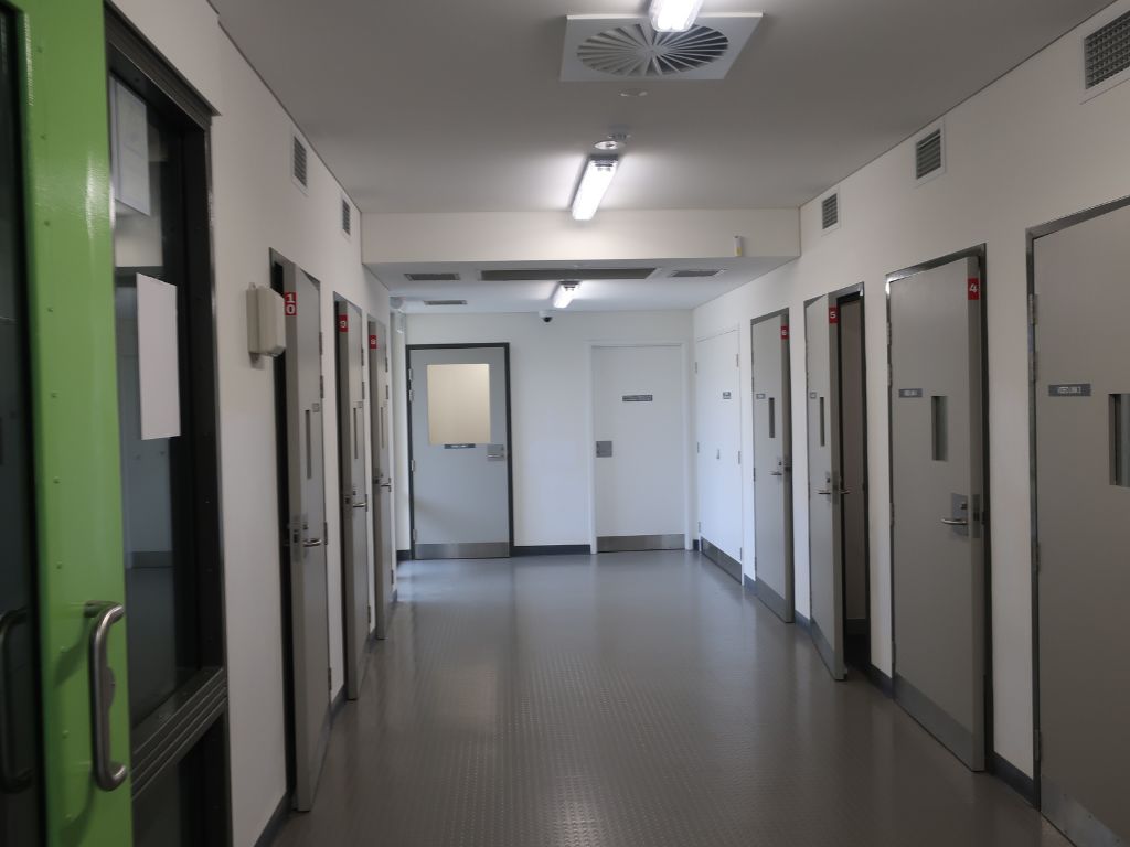 Image of corridor with doors to the video link pods at Casuarina Prison