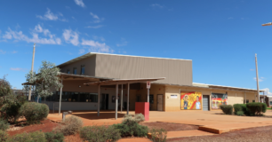 Image of outside the gym with murals on the wall, at Eastern Goldfields Regional Prison
