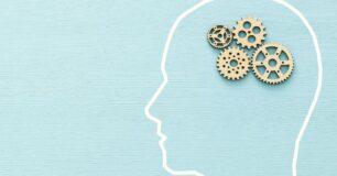 Image of an outline of a person's head, with cog wheels as a brain