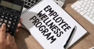 Image of the words Employee Wellness Program written on a notepad in capital letters.