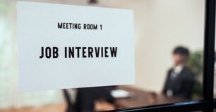 Image of a sign with the wording 'job interview', on a window.